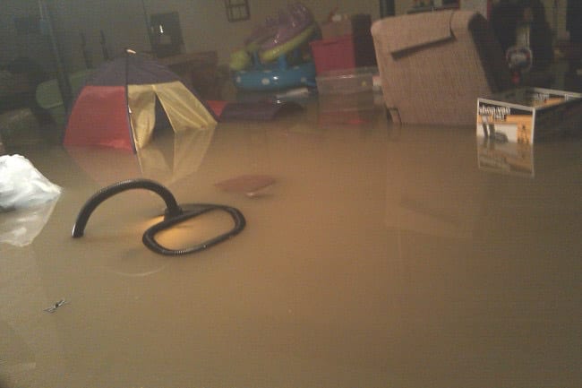 Flooded room from possible clogged sewer backup or clogged drain backup needing sewer cleaning or drain cleaning